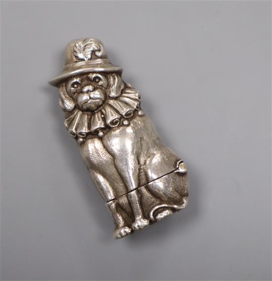 A novelty white metal vesta case, modelled as a seated dog wearing a hat, the interior stamped silver, 59mm.